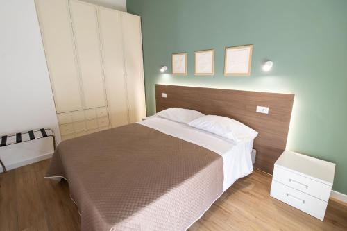 a bedroom with a large bed with a wooden headboard at B&B Sila in Fiore in San Giovanni in Fiore