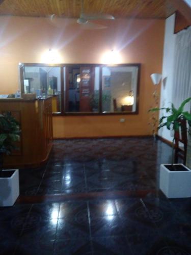 a room with a lobby with potted plants in it at Dennisse Hotel in Victoria