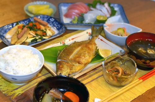 a table topped with plates of food and bowls of food at Uminoie Painukaji in Iriomote