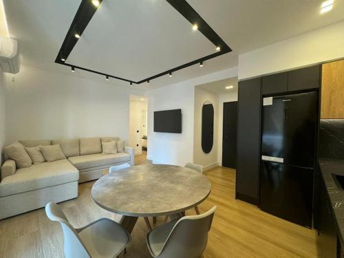 a living room with a table and a couch at BlueMotion - PortSuite 4A in Piraeus