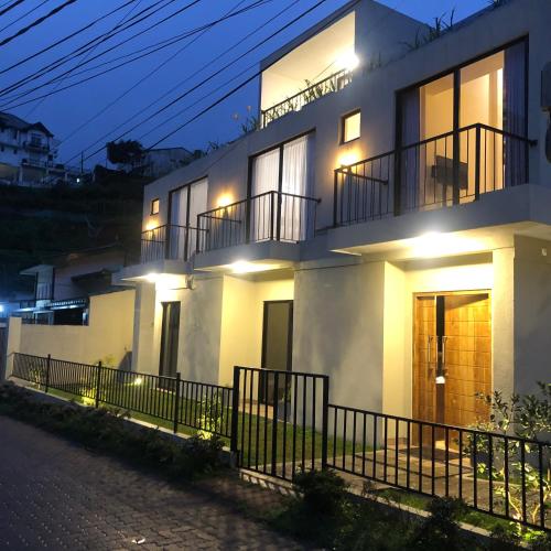 a white house with lights on it at night at R21 Nuwara Eliya in Nuwara Eliya