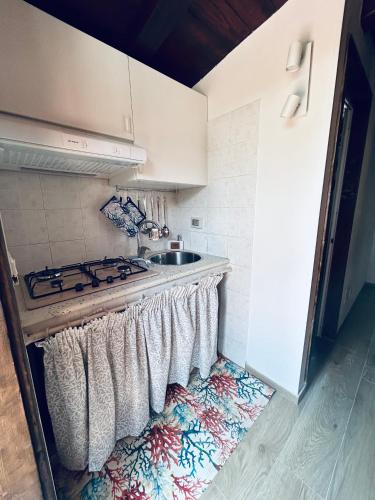 a kitchen with a stove with towels hanging on it at Chalet Seaview by AR Group Hotels in Isola delle Femmine