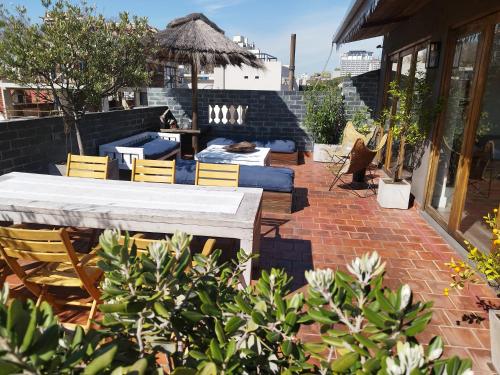a patio with a table and chairs on a brick patio at Hotel Costa Rica in Buenos Aires