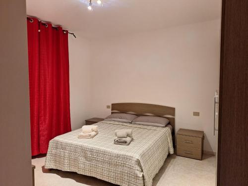 a bedroom with a bed with two towels on it at DaPa Home in Selargius