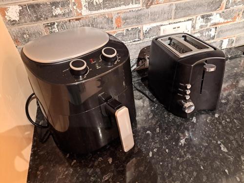 a slow cooker and a toaster sitting on a counter at The Quaint Old Shop in Tewkesbury