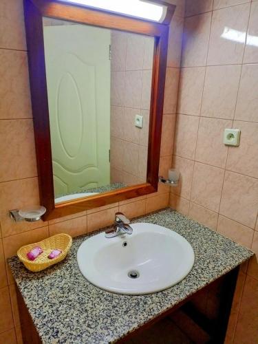 a bathroom counter with a sink and a mirror at Quality Inn Hotel Kigali in Kigali