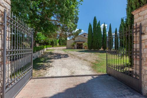 an entrance to a driveway with an iron gate at Podere del Monte in Amelia