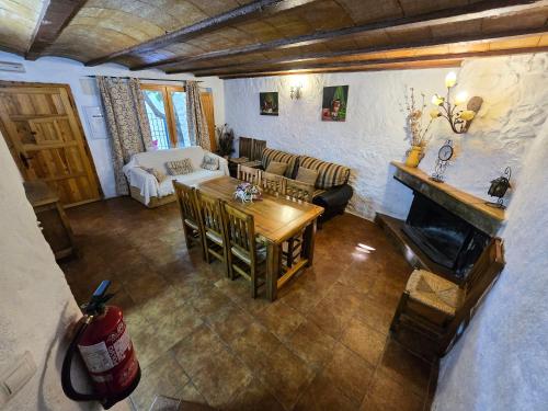 a living room with a table and a fireplace at Casas Rurales La Tejeruela in Yeste