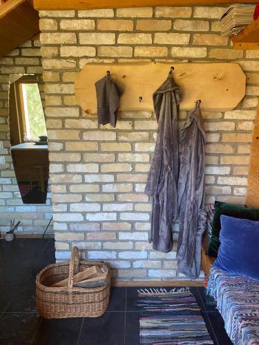 a brick wall with clothes hanging on it at Pirtsmāja Villa Marta in Cēsis