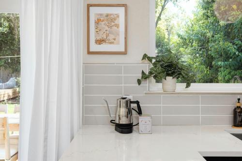 a kitchen with a coffee maker on a counter next to a window at Austin Oasis Zilker, Downtown, Pool, 3 Bedroom in Austin