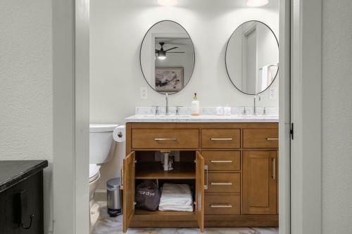 a bathroom with a sink and two mirrors at Austin Oasis Zilker, Downtown, Pool, 3 Bedroom in Austin