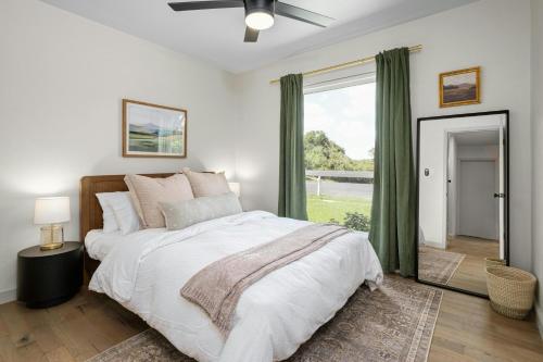 a bedroom with a bed and a large window at Austin Oasis Zilker, Downtown, Pool, 3 Bedroom in Austin