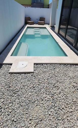 a swimming pool on the side of a building at Los Cosos Mansion - Sleep 6 in Palm-Eagle Beach