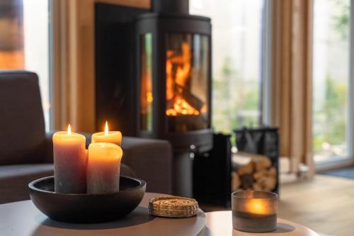 a group of candles sitting on a table in front of a fireplace at Moose Lodge - 6p - With Sauna & Water View in Vradal
