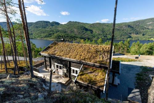 an old house with grass on the roof at Moose Lodge - 6p - With Sauna & Water View in Vradal