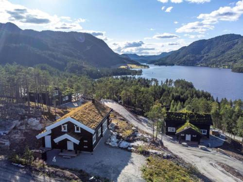 an aerial view of a house next to a lake at Moose Lodge - 6p - With Sauna & Water View in Vradal