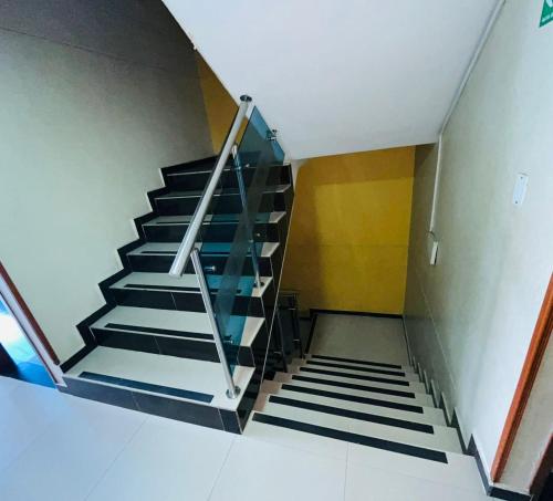 a staircase in a building with black and white stairs at Hotel Bucarica Plaza in Bucaramanga
