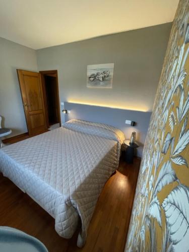 a bedroom with a white bed in a room at La Bomboniera in Cervia