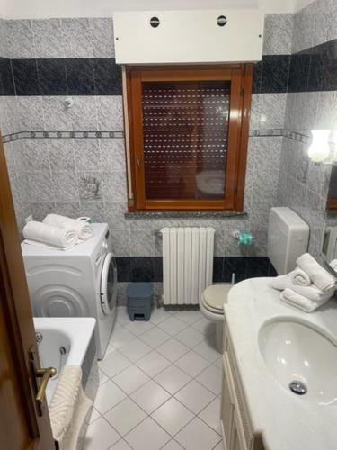 a bathroom with a sink and a toilet and a sink at La Bomboniera in Cervia