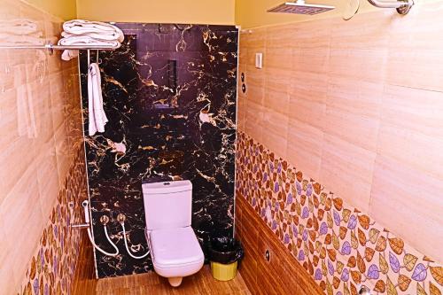 a bathroom with a pink toilet in a room at JSN Grand in Srikalahasti