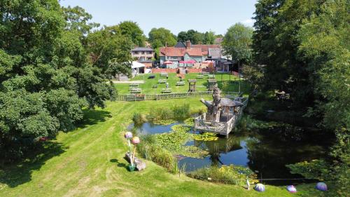 an aerial view of a garden with a boat in the water at The Bell Inn in Wendens Ambo