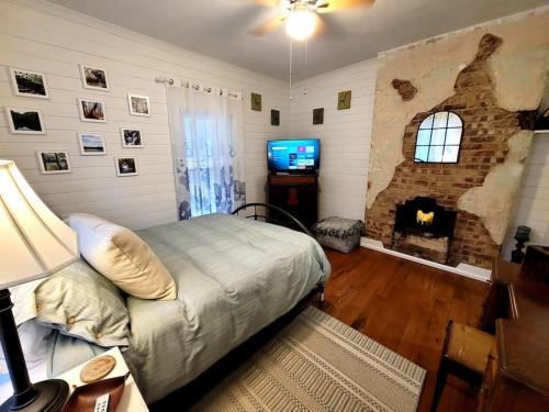 a bedroom with a bed and a stone fireplace at Apple Hill Bungalow, Family and PET Friendly! in Bristol