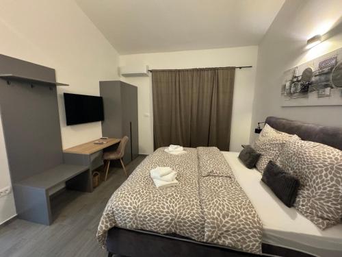 a bedroom with a bed and a desk and a computer at Villa Mario in Poreč