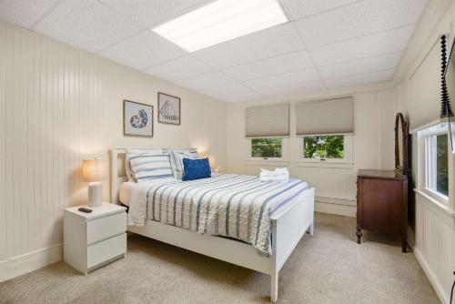 a white bedroom with a bed and a window at Cozy Retreat on Commercial Street for 2 in Provincetown