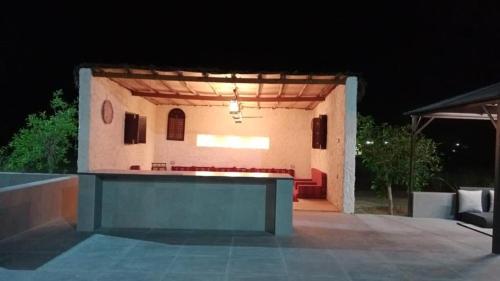 a building with a group of chairs in front of it at Thefarm rak in Al Ḩamrānīyah