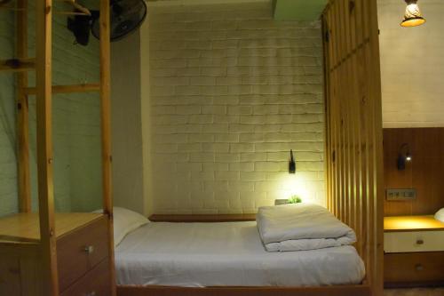 a bedroom with a bunk bed with white sheets at Julley Commune Rishikesh in Rishīkesh