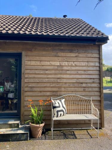 a bench sitting in front of a building at The hide away in Glenties