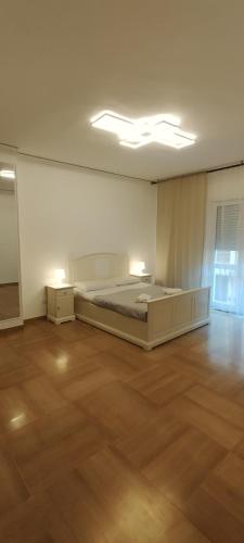 a bedroom with a bed in a room with wooden floors at Odysea in Comiso