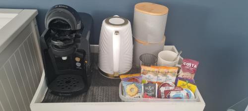 a kitchen counter with a food processor and other items at Large Double Room with Ensuite and double shower - Homestay in Bishops Frome