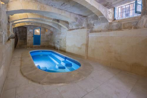 a room with a swimming pool in a stone building at Room 8 - Couples room x 2 by Solea in Għarb
