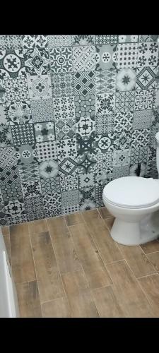 a bathroom with a toilet and a tile wall at Apartamento de lujo en Valencia 2 in Valencia