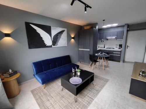 a living room with a blue couch and a table at Apartamento de lujo en Valencia 2 in Valencia