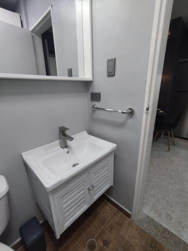 a white bathroom with a sink and a mirror at Apartamento de lujo en Valencia 2 in Valencia