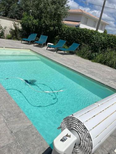 - une piscine avec des nouilles dans l'eau dans l'établissement Maison 3 chambres avec piscine, à Andernos-les-Bains