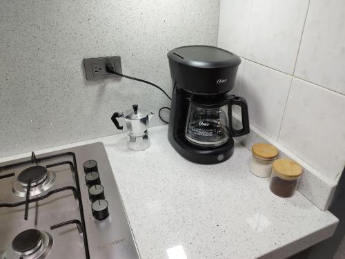 a coffee maker sitting on a counter next to a stove at Apartamento de lujo en Valencia 2 in Valencia