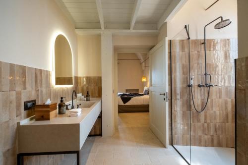 a bathroom with a shower and a sink at Masseria Donna Menga - The Leading Hotels of the World in Torre Lapillo