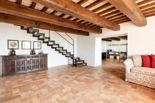 an open living room with wooden ceilings and a staircase at Banditella in Orvieto