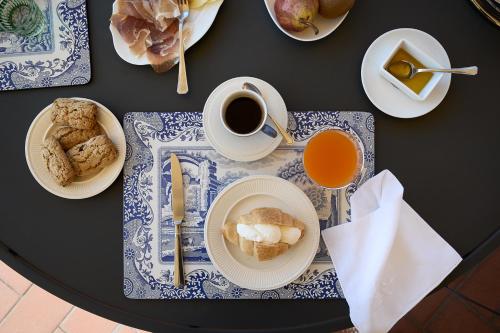 a table with plates of food and a cup of coffee at Albergo Villa Cristina in Spoleto
