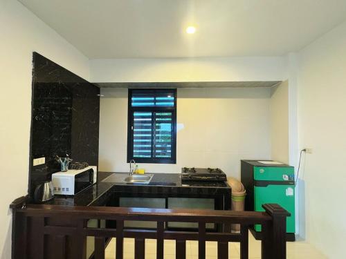 a kitchen with a sink and a counter top at High Life Villas in Salad Beach