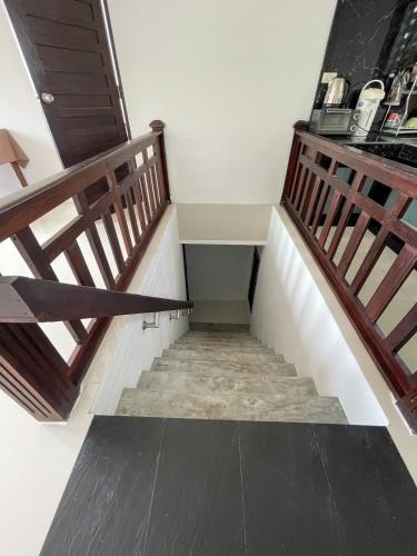 a staircase in a house with wooden railings at High Life Villas in Salad Beach