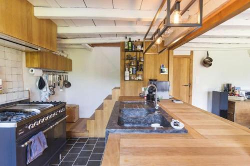 a kitchen with a sink in the middle of it at City Farmhouse and studio in Roeselare