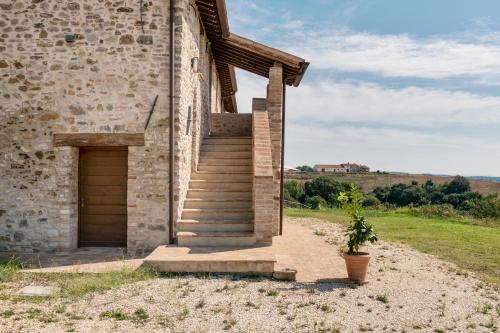 a brick building with a staircase and a door at Banditella in Orvieto