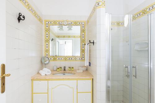 a bathroom with a sink and a mirror and a shower at Villa Nannina in Positano