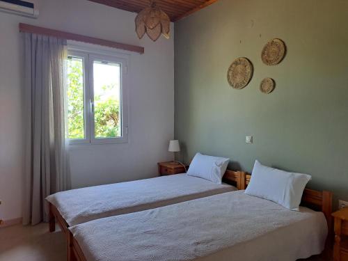 Ένα ή περισσότερα κρεβάτια σε δωμάτιο στο Holiday Home Orfanos