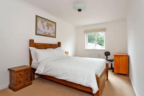a bedroom with a large white bed and a window at Spacious 4 bedroom Townhouse near Scenic Beach & City Centre in Aberdeen