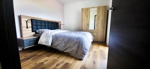 a bedroom with a bed and a wooden floor at Villa laudun in Laudun